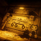 Decorative setup with a 'Music Department' sign, cassette tape, and plush toys in a dimly lit room.