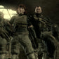 Four characters in futuristic military attire standing in a dimly lit room.